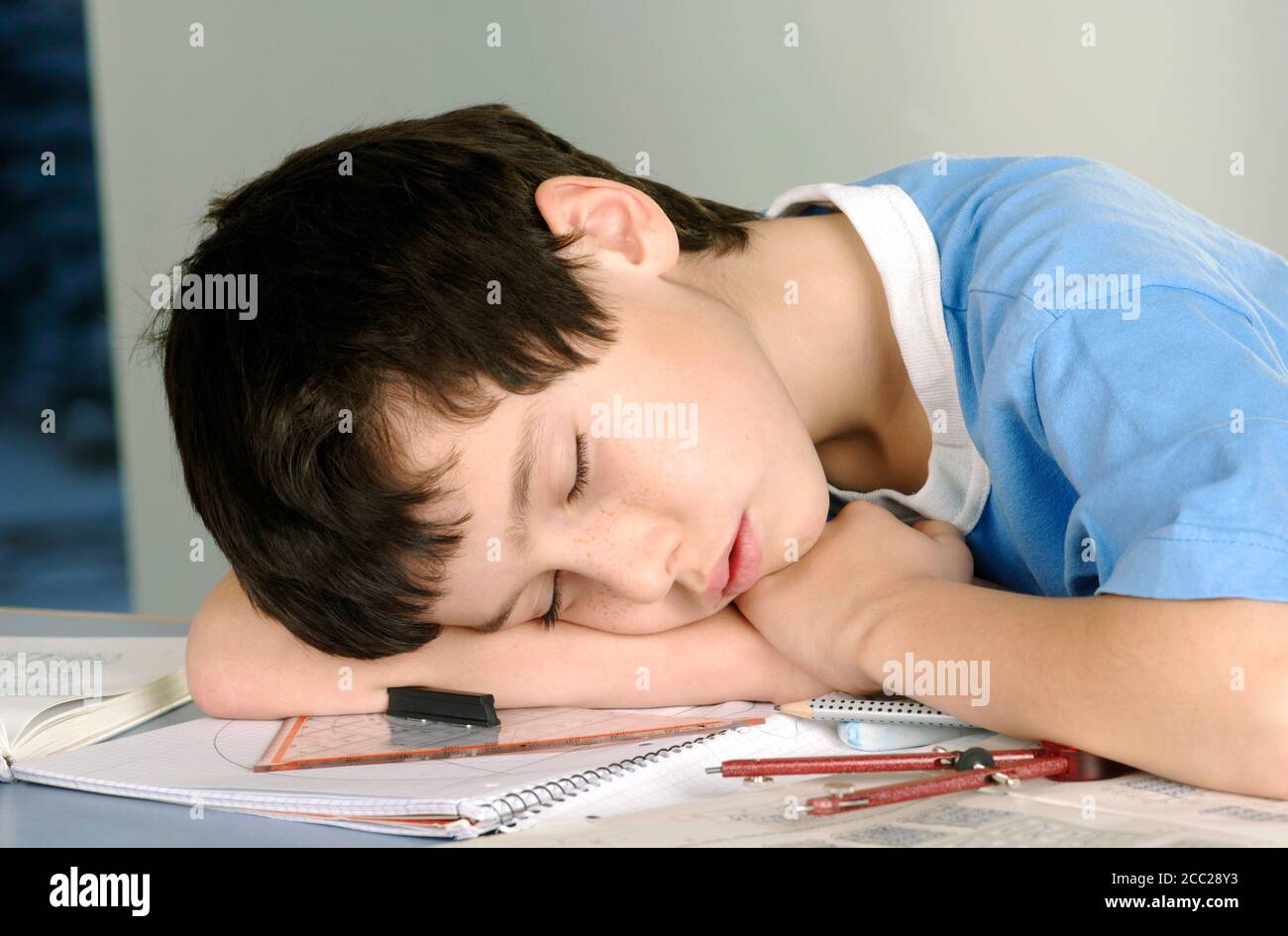 Boy tired from doing his homework Stock Photo