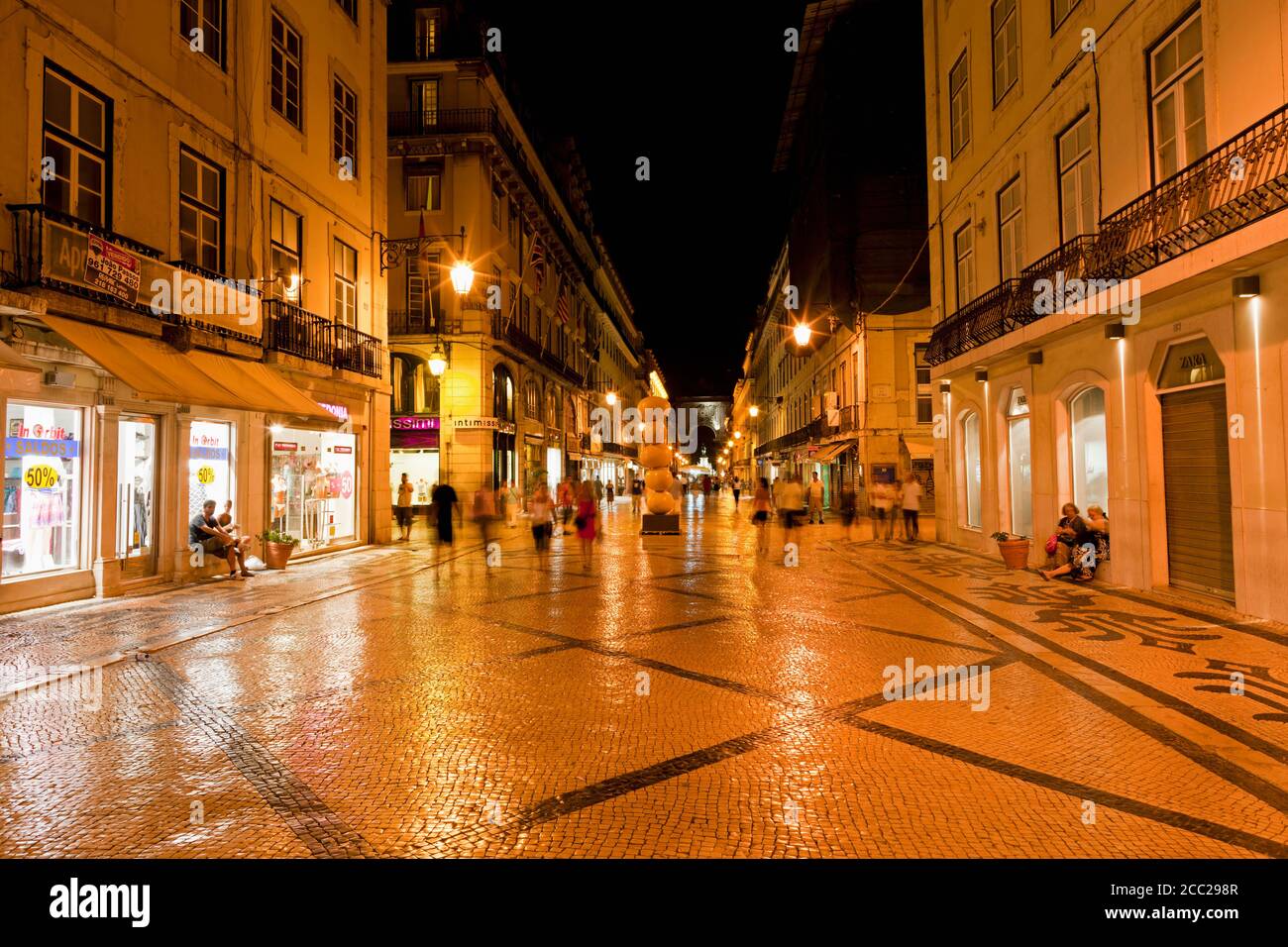 Europe, Portugal, Lisbon, Baixa, View of Rua Augusta road with pedestrian and shopping mile at night Stock Photo