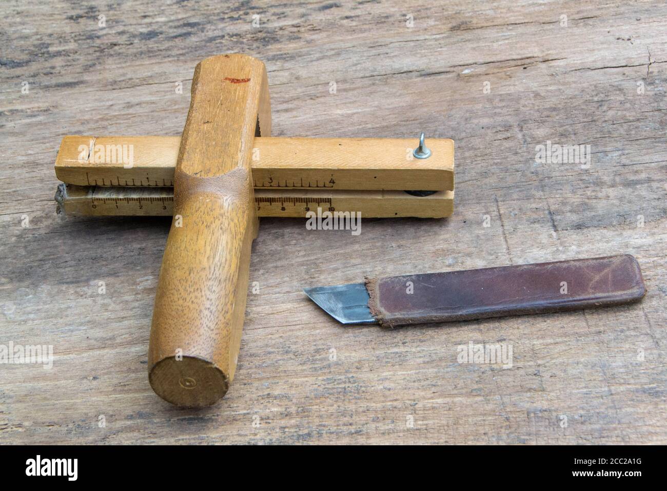 Leather Working Tools And Rolled Up Hide Organized Stock Photo