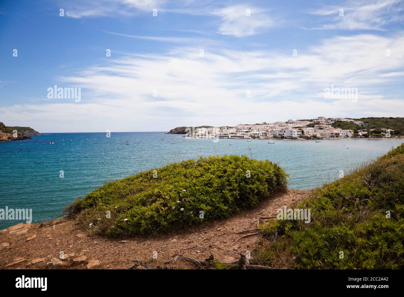 Spain, Menorca, Es Grau bay with fishing village in background Stock Photo