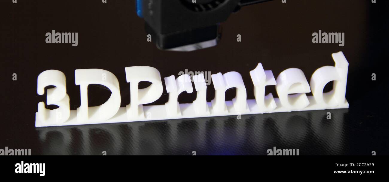 a 3D printer printing the text "3d printed" Stock Photo