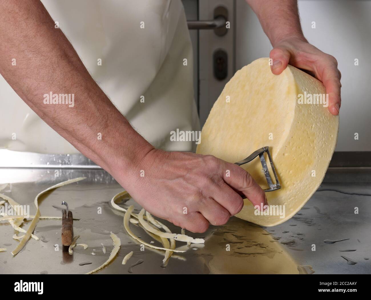 Mature man cutting border of cheese hires stock photography and images