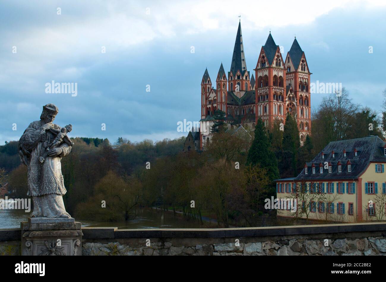 Germany, Hesse, View of Limburg cathedral with statue in front Stock Photo