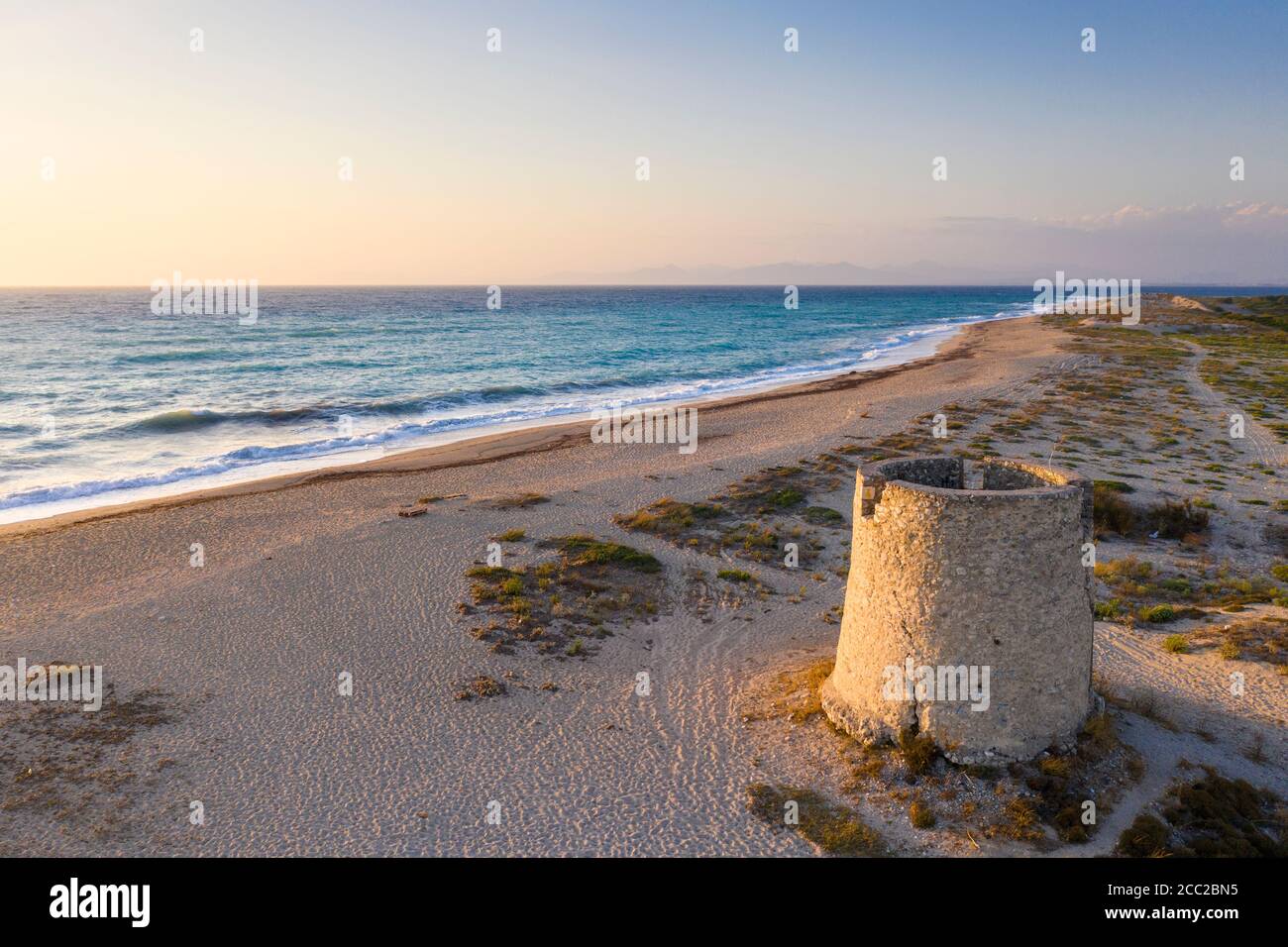 Sunset over a ruined windmill at Paralia Agios Ioannis, Lefkada, Ionian Islands, Greece Stock Photo