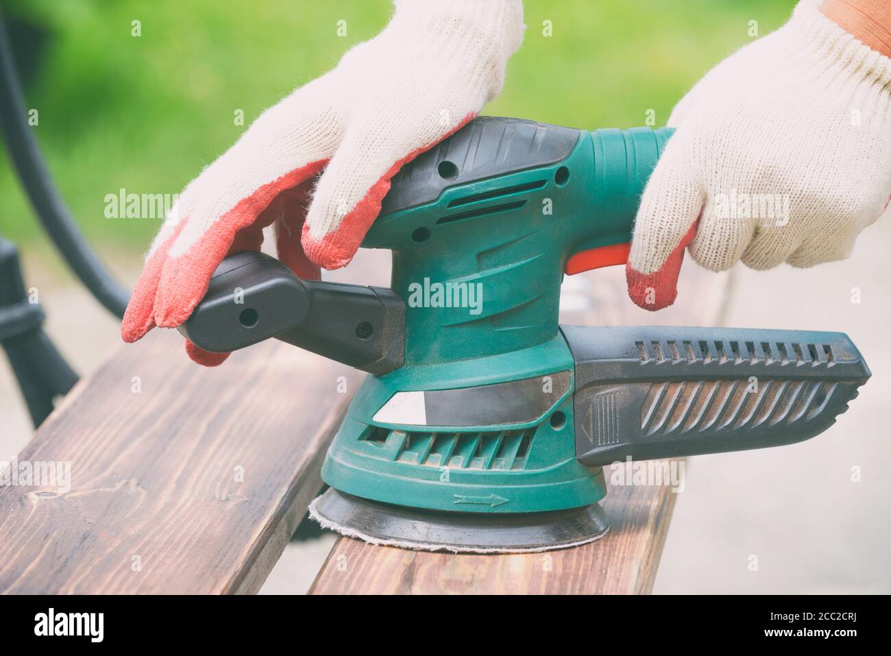 Sanding a wood with orbital sander outdoor Stock Photo Alamy