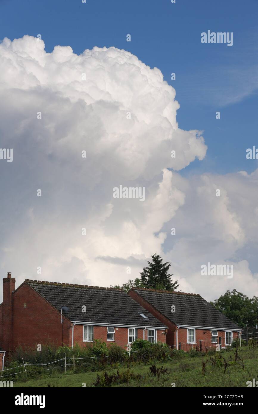 Romsley, Worcestershire, August 17th 2020. Dramatic clouds loomed over houses in Romsley, Worcestershire on Monday afternoon as thunder and lightning continued to form during the hot weather. Torrential rain has hit the region but is expected to calm down in the week ahead. Credit: Sam Holiday/Alamy Live News Stock Photo