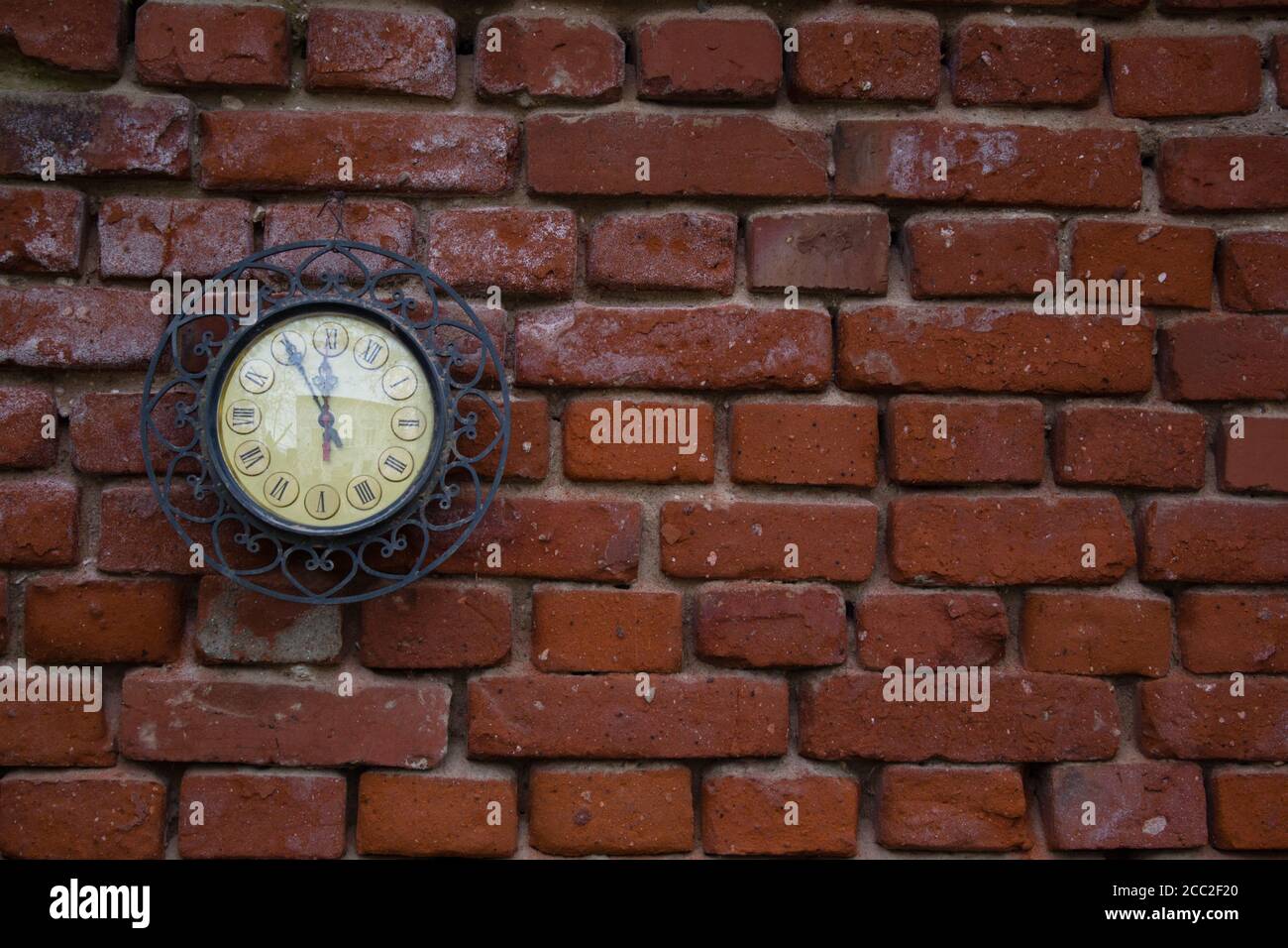 A Vintage Station Clock On A Red Brick Wall Stock Photo - Alamy