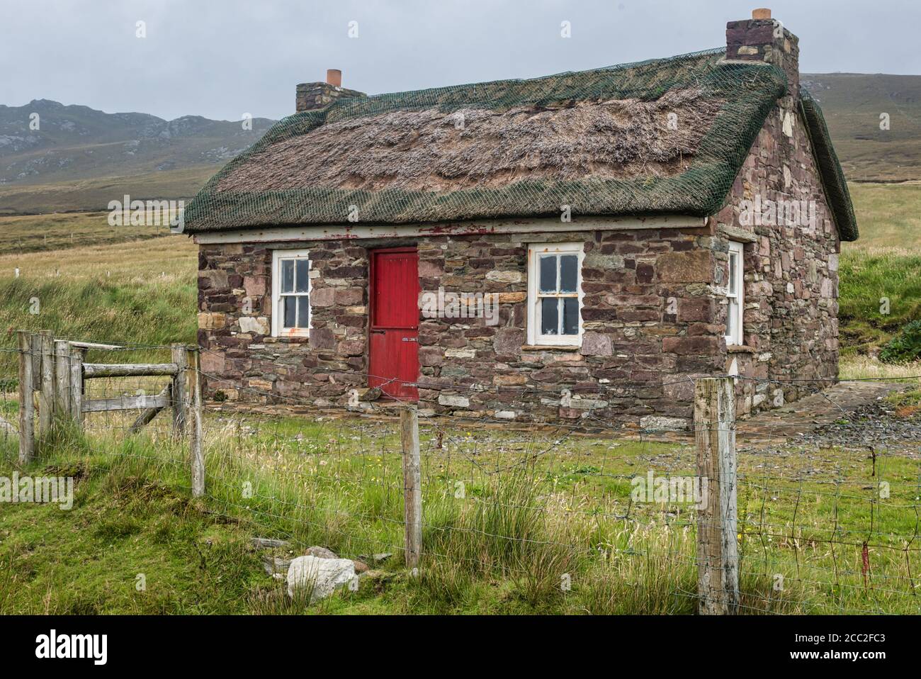 Achill Island, Ireland- Jul 31, 2020: A small traditional Irish thatched cottage. Stock Photo