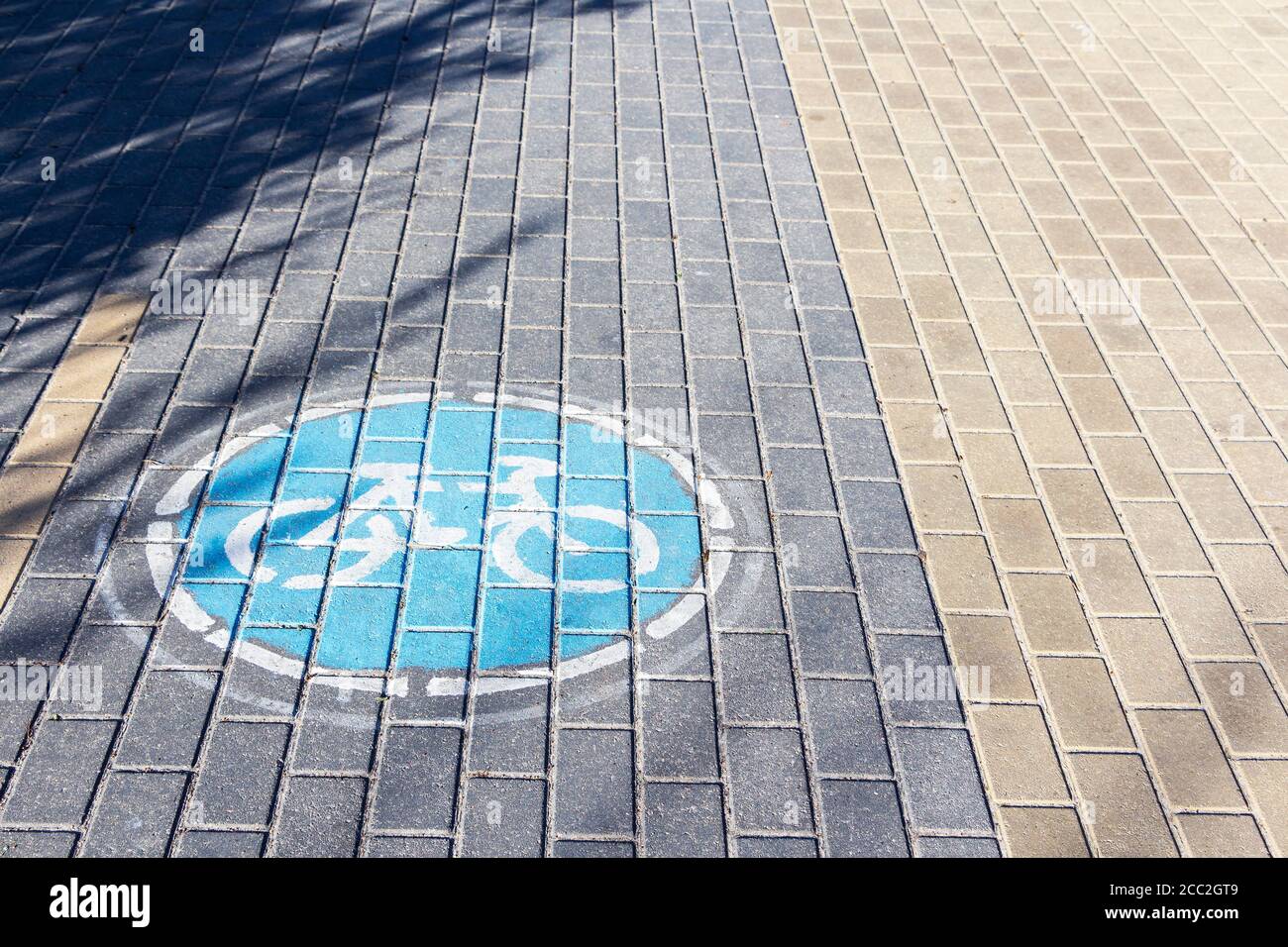 sign Bicycle path on the paving slabs in the Park Stock Photo