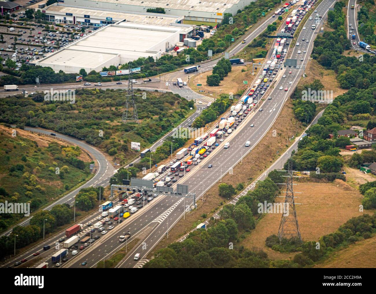 Horizontal aerial view of traffic backed up on the approach to the Dartford bridge at Lakeside, Great Britain. Stock Photo