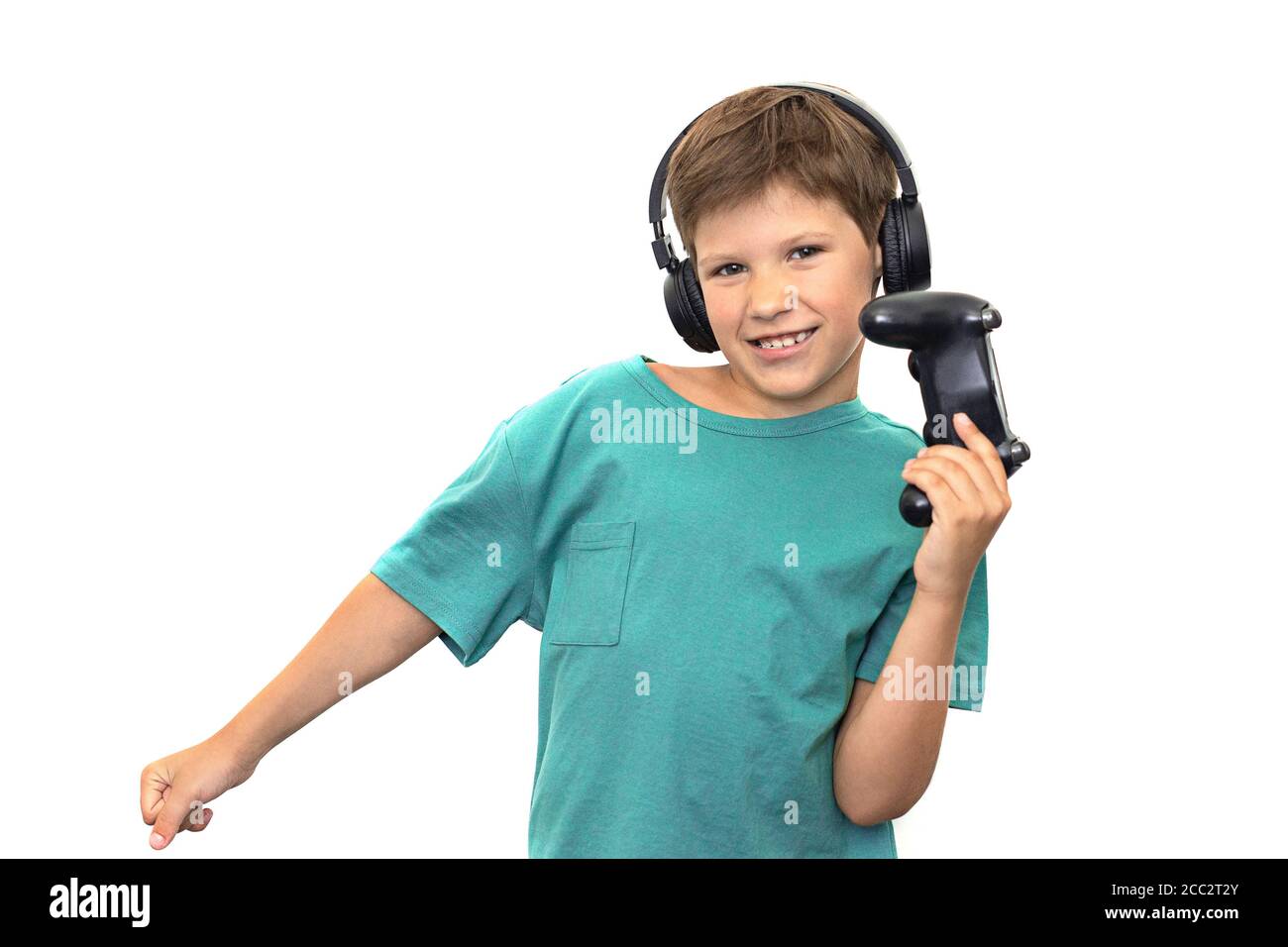 Boy plays a computer game with headphones and a joystick, game console. Stock Photo