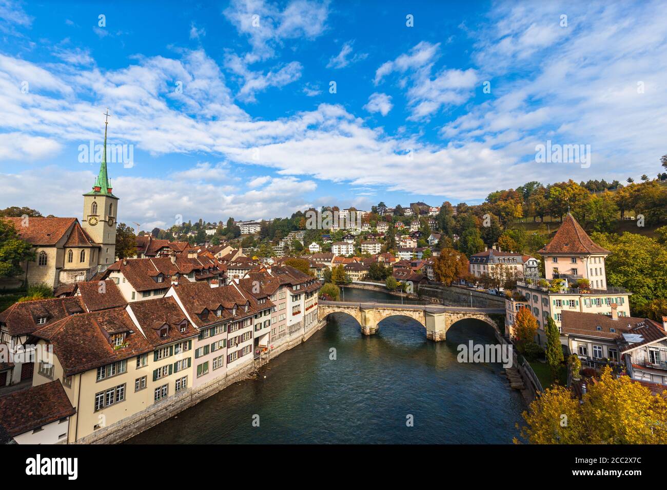 Beautiful view of Bern old town and Aare river from Nydeggbrücke bridge with Nydeggkirche church and Untertorbrücke, on sunny autumn day with blue sky Stock Photo