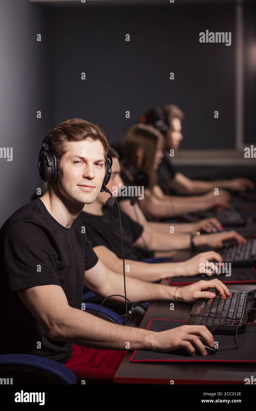 Pleased american hardcore fan working on a computer screen in a dark ...