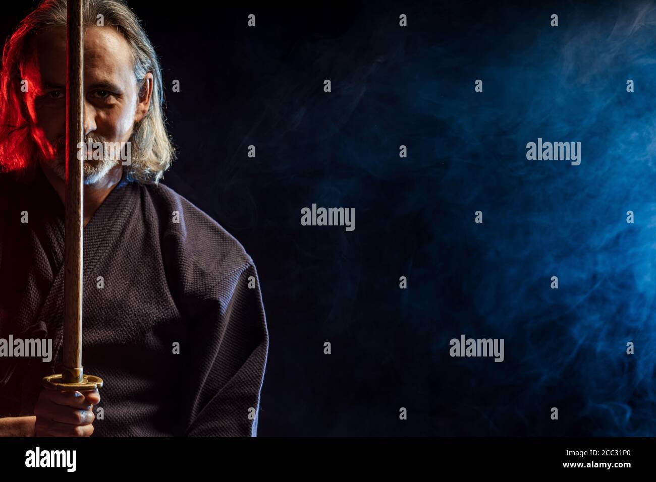 portrait of caucasian kendo fighter with bokuto, bamboo sword shinai
