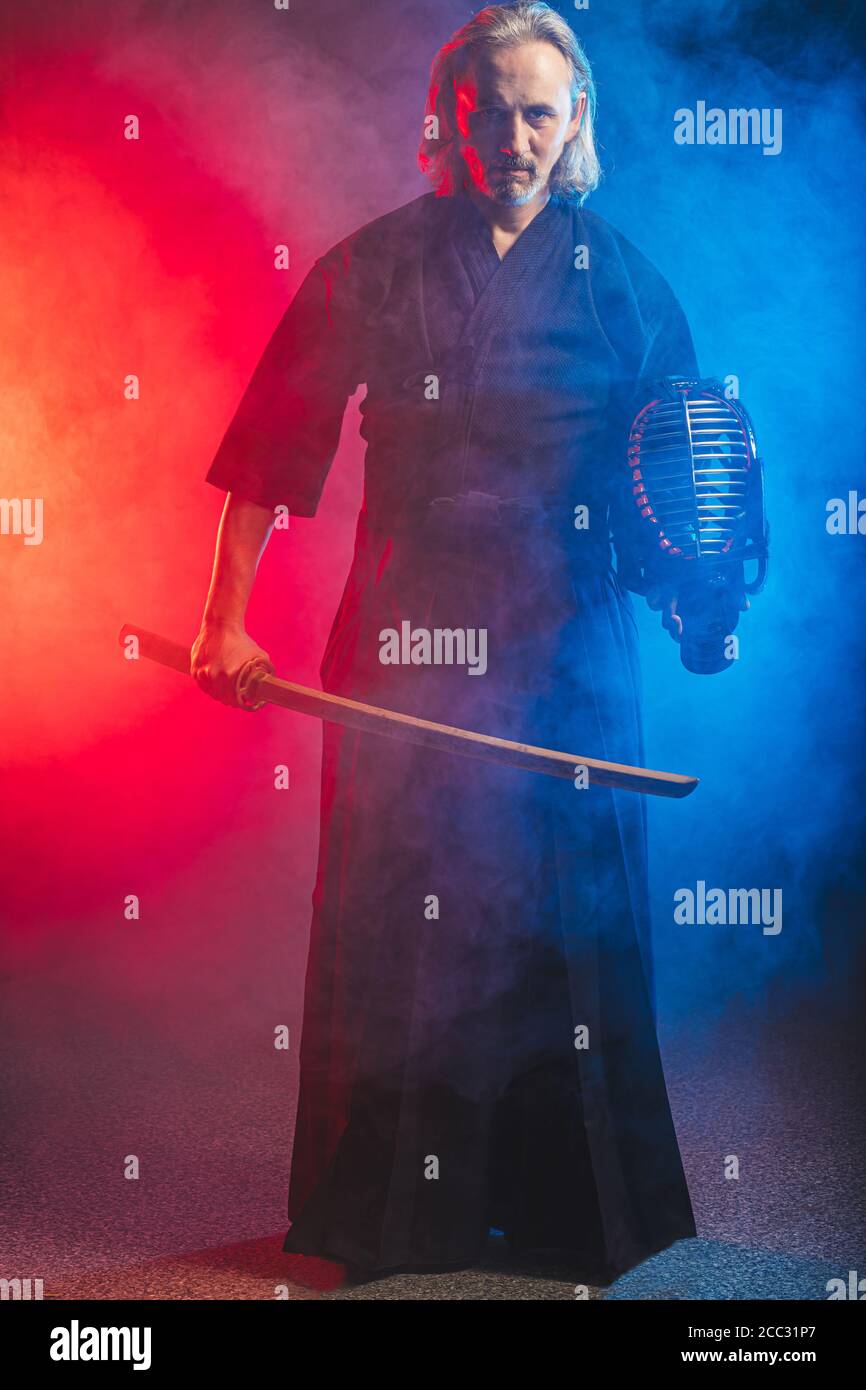 portrait of caucasian kendo fighter with bokuto, bamboo sword shinai. traditional japanese