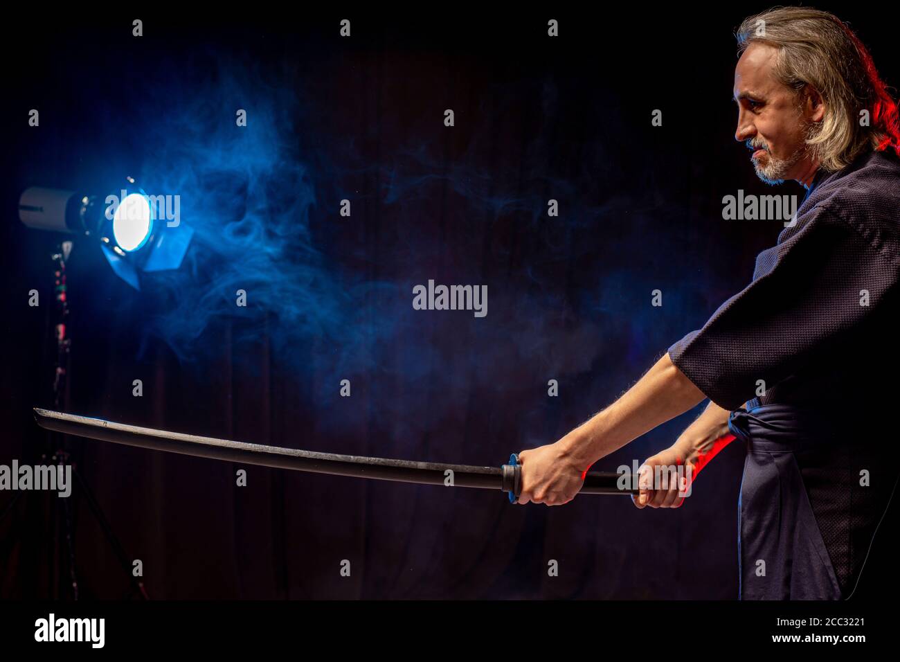 portrait of caucasian man kendo fighter with bokuto bamboo sword shinai . japanese traditional