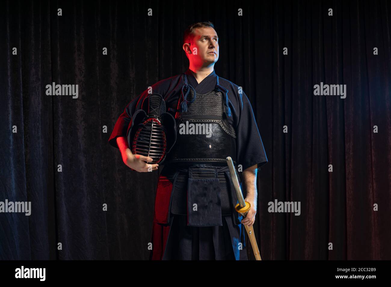 portrait of caucasian kendo fighter with bokuto, bamboo sword shinai. traditional japanese