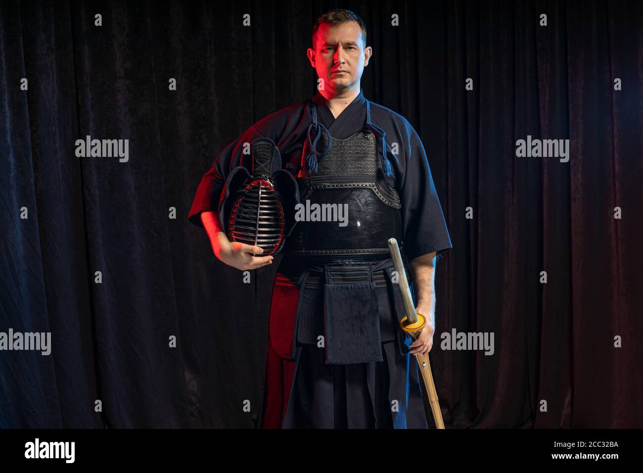 portrait of caucasian man kendo fighter with bokuto bamboo sword shinai