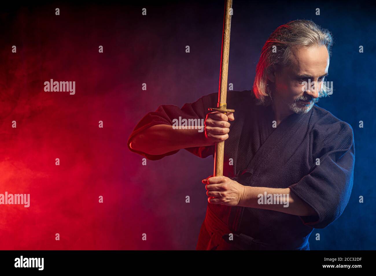 real caucasian mature kendo fighter ready to fight with enemy using bamboo sword shinai