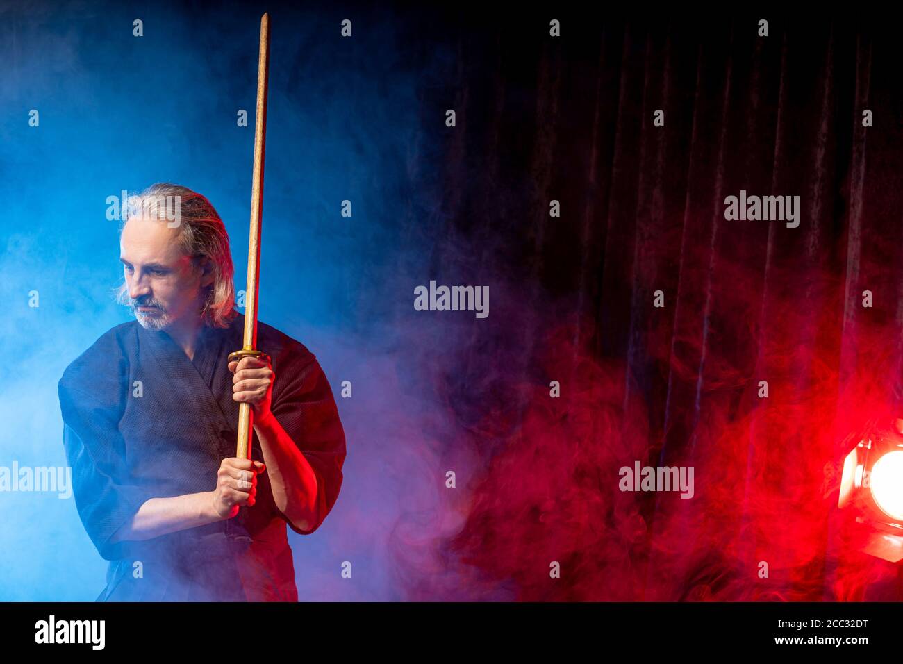 portrait of caucasian kendo fighter with bokuto, bamboo sword shinai