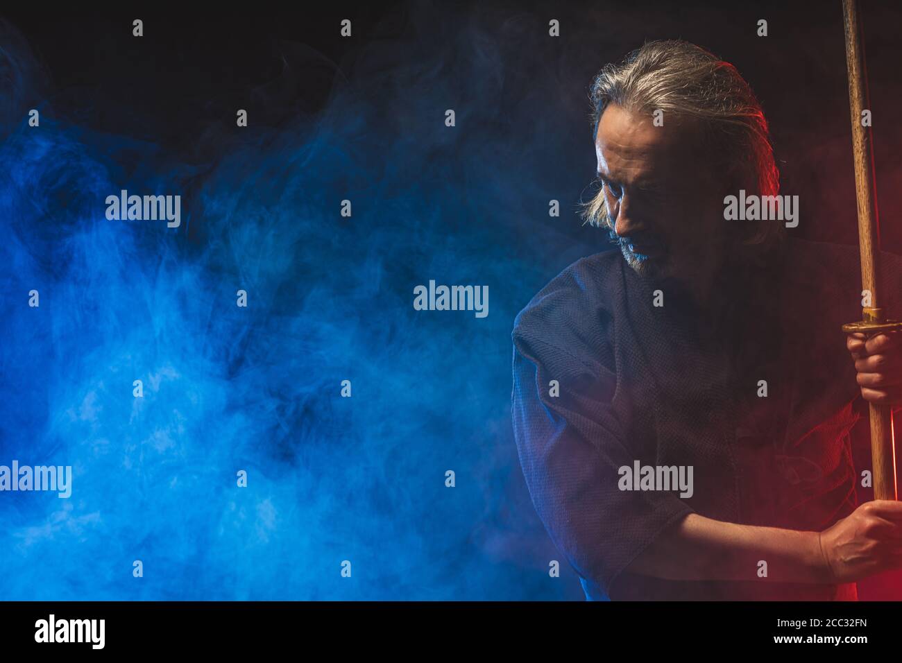 handsome strong kendo fighter in traditional kendo outfit dress stand with  shinai, going to fight. mortal warrior isolated over smoky space Stock  Photo - Alamy