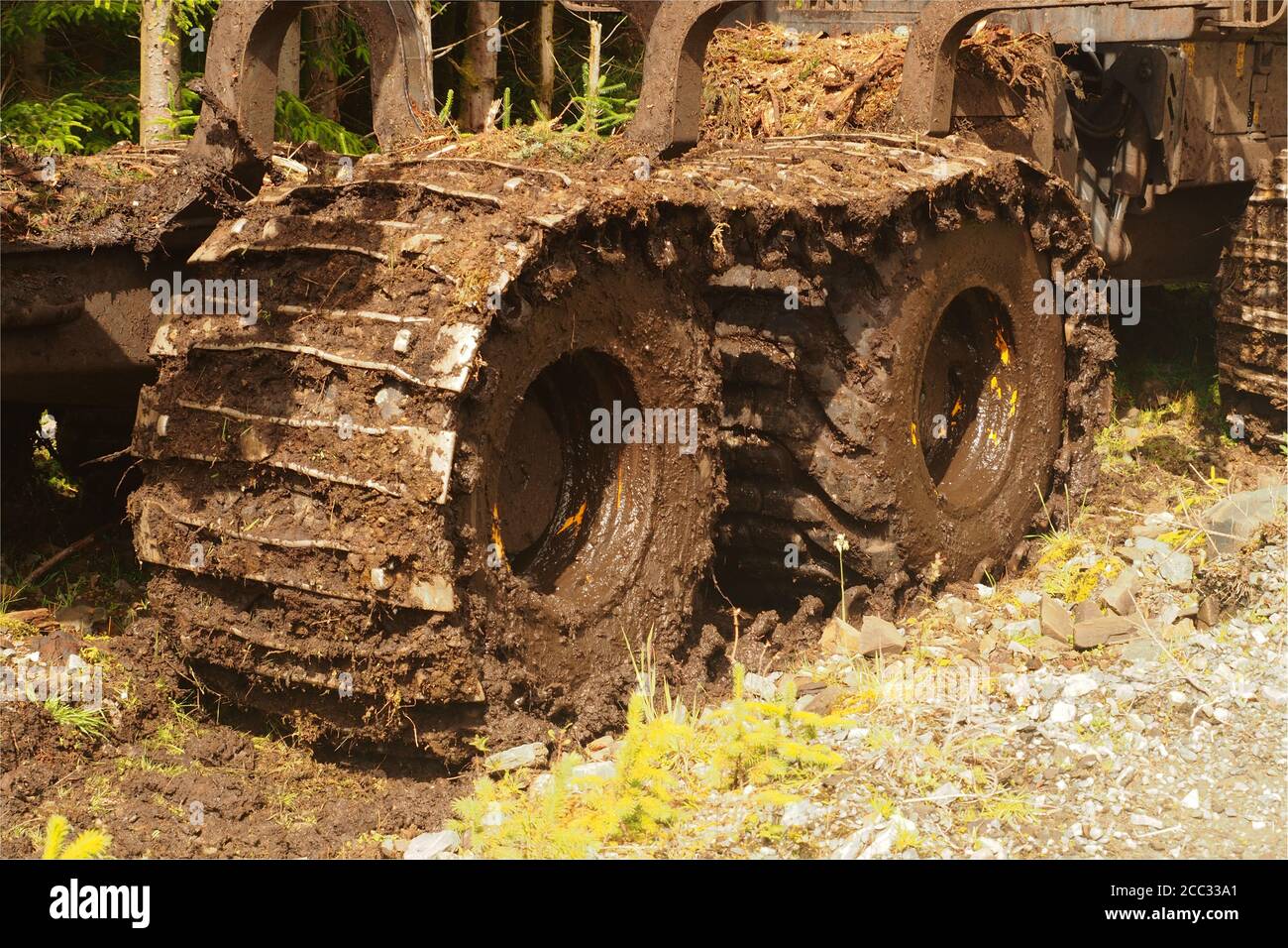 A Ponsse Forwarder, heavy duty log cutting and loading machine, at the side of a forestry track waiting to be used in Eredine Forest, Argyll, Scotland Stock Photo