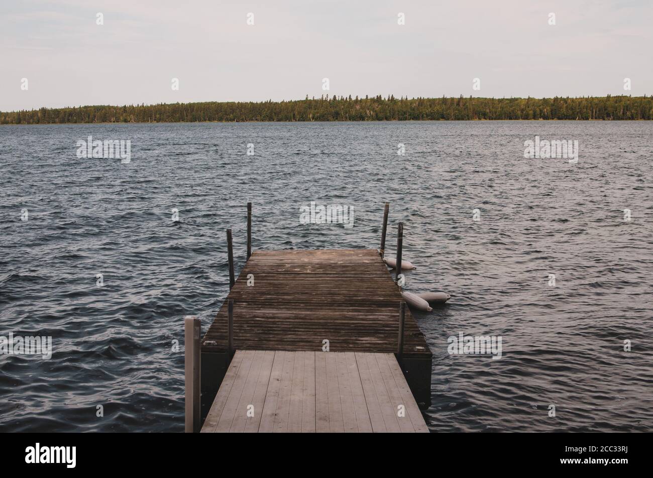 Dock and wavy water on Child's Lake in Duck Mountain Provincial Park, Manitoba, Canada Stock Photo