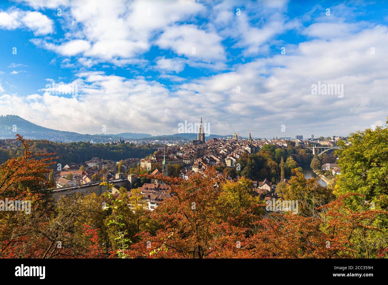 Stunning aerial panorama view of Bern old town with Bern Minster (Münster) cathedral and Aare river, from Rosengarten on sunny autumn day with blue sk Stock Photo