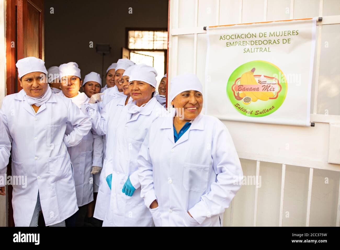 Women from a local banana growers' cooperative stand together for a