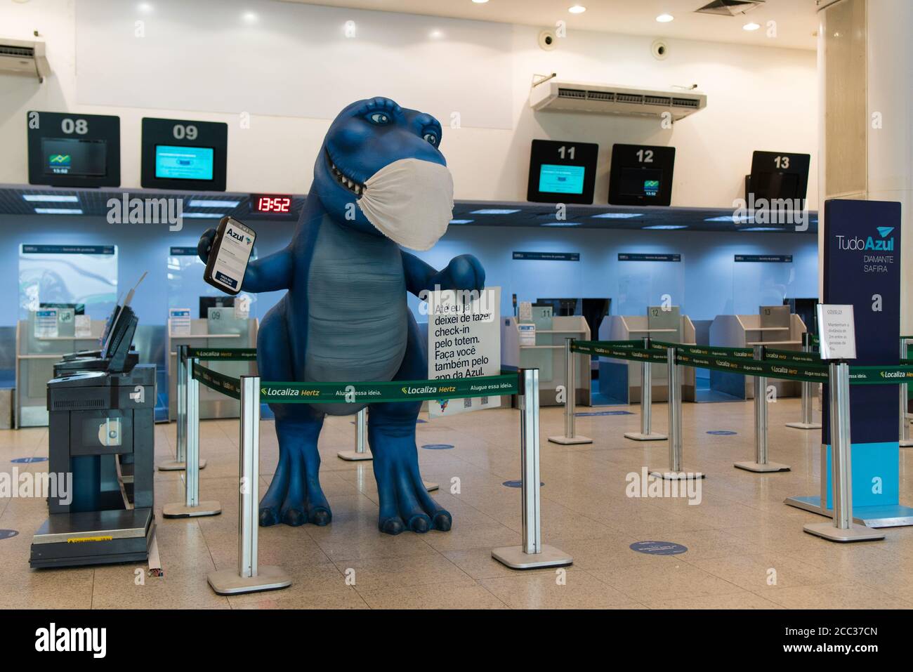 Rio de Janeiro, Brazil - July 16, 2020: Blue dinosaur with protective face mask at the check in counter in Santos Dumont airport. Stock Photo