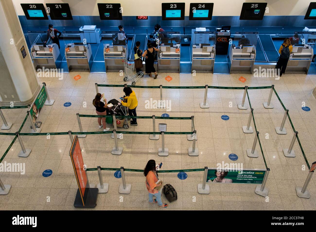 Rio de Janeiro, Brazil - July 16, 2020: Very few travelers at the check in counter at Santos Dumont airport during the Coronavirus pandemic. Stock Photo