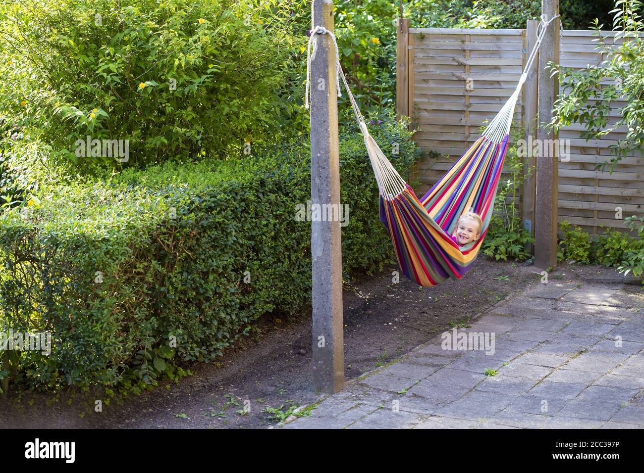 Girl (8) in hammock in garden, Kiel, Schleswig-Holstein, Germany Stock Photo