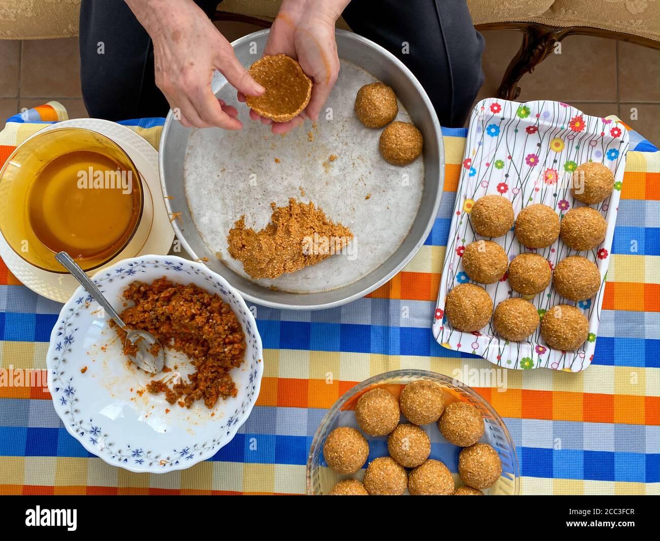 Traditional Turkish Food; Stuffed Meatballs,  Turkish known as 'icli kofte'. Woman making Stuffed Meatballs at home. Stock Photo