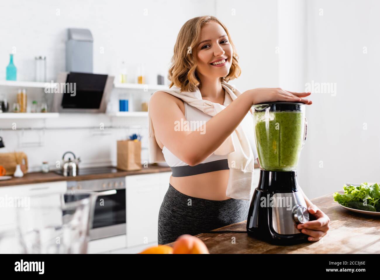 focus of young woman green smoothie in blender Stock Photo - Alamy