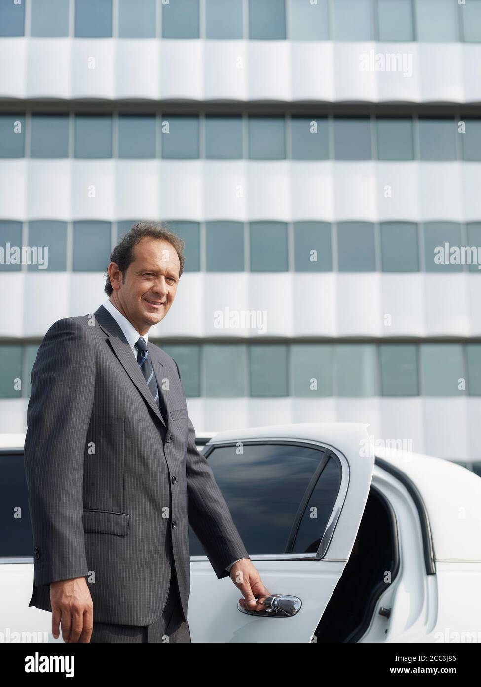Portrait Of Man Working As Driver In White Limousine Stock Photo