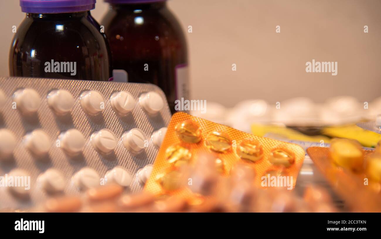 Bottles and pills. A tablet is the solid form of a medicated powder, prepared by compression, with or without added binders. Slots may be provided to Stock Photo