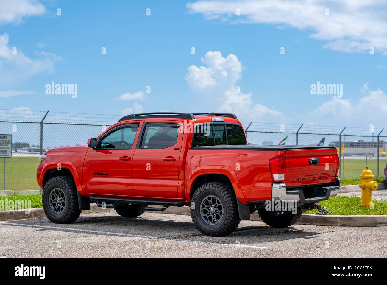 Photo of a red Toyota Tacoma in a parking lot Stock Photo