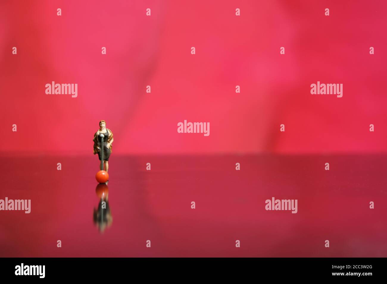 Miniature photography - elegant women singer singing on shiny red stage shiny floor Stock Photo