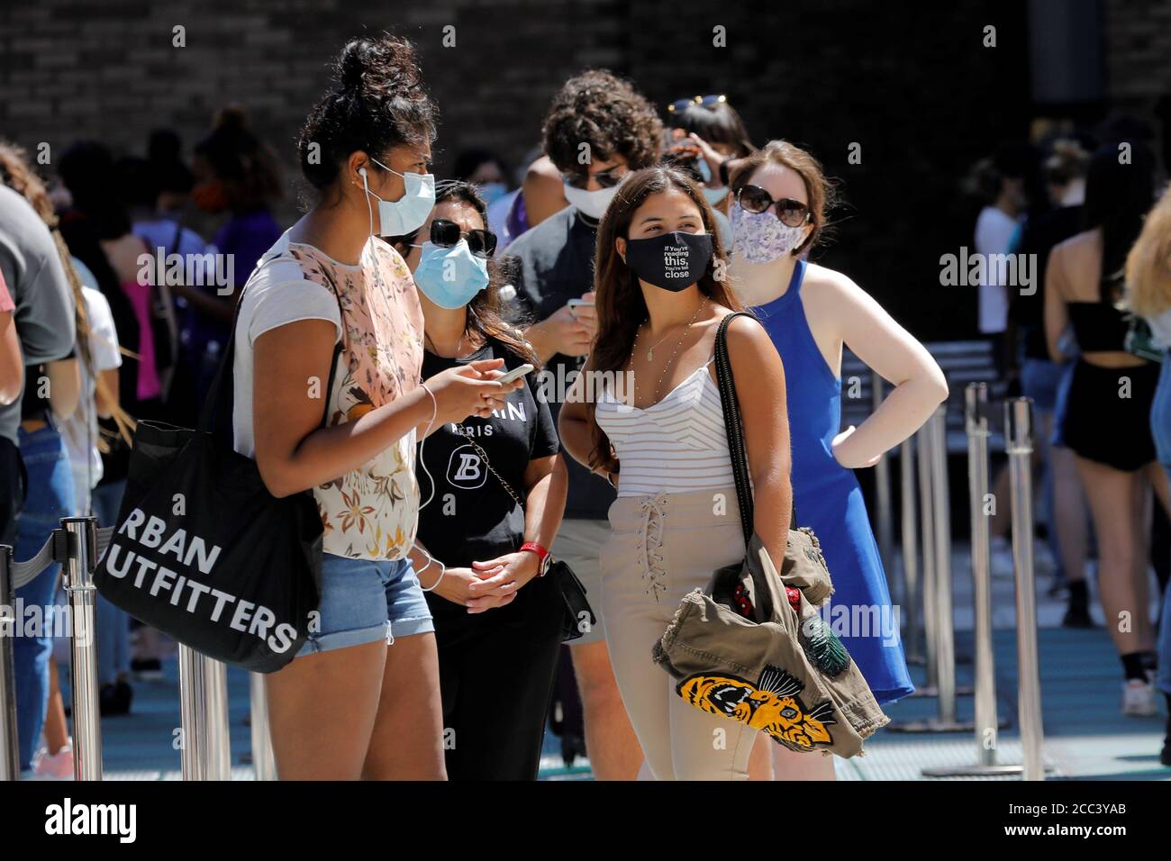 Students Wear Protective Masks As They Wait In Line At A Testing Site For The Coronavirus