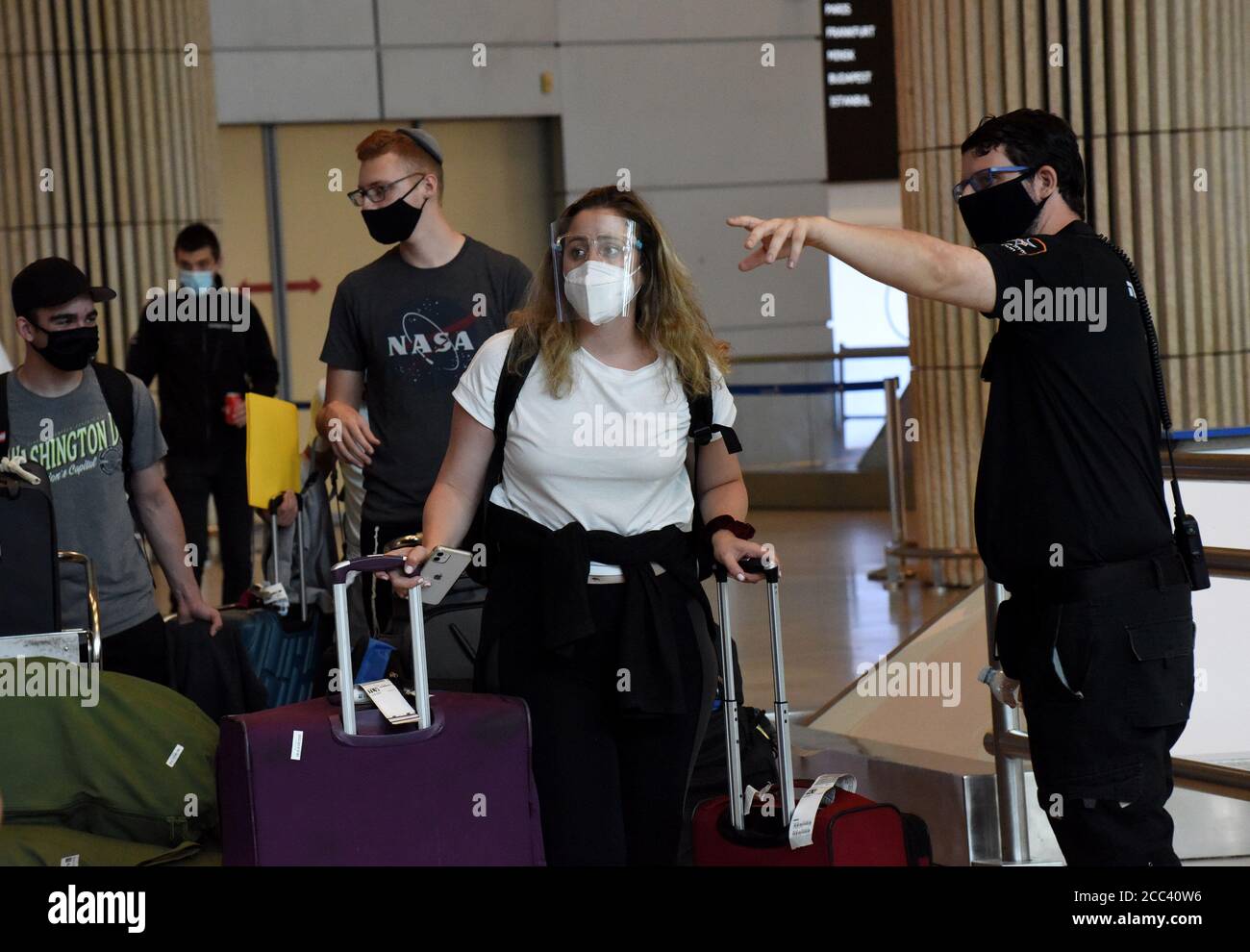 Lod, Israel. 18th Aug, 2020. Travelers wearing protective masks arrive at Ben Gurion International Airport, in Lod, near Tel Aviv, as Israel eases coronavirus air travel restrictions, Tuesday, August 18, 2020. Israelis can travel quarantine free to and from Greece, Croatia and Bulgaria and allowed to return from 17 countries without quarantine. Tourists from defined 'green' countries can enter Israel without mandatory quarantine. Photo by Debbie Hill/UPI Credit: UPI/Alamy Live News Stock Photo