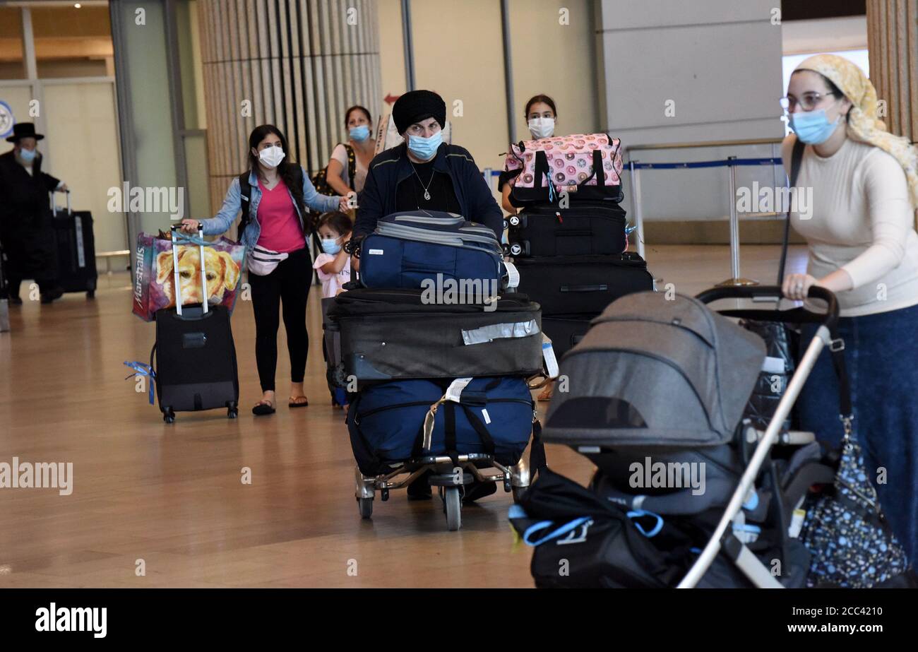 Lod, Israel. 18th Aug, 2020. Travelers wearing protective masks arrive at Ben Gurion International Airport, in Lod, near Tel Aviv, as Israel eases coronavirus air travel restrictions, Tuesday, August 18, 2020. Israelis can travel quarantine free to and from Greece, Croatia and Bulgaria and allowed to return from 17 countries without quarantine. Tourists from defined 'green' countries can enter Israel without mandatory quarantine. Photo by Debbie Hill/UPI Credit: UPI/Alamy Live News Stock Photo
