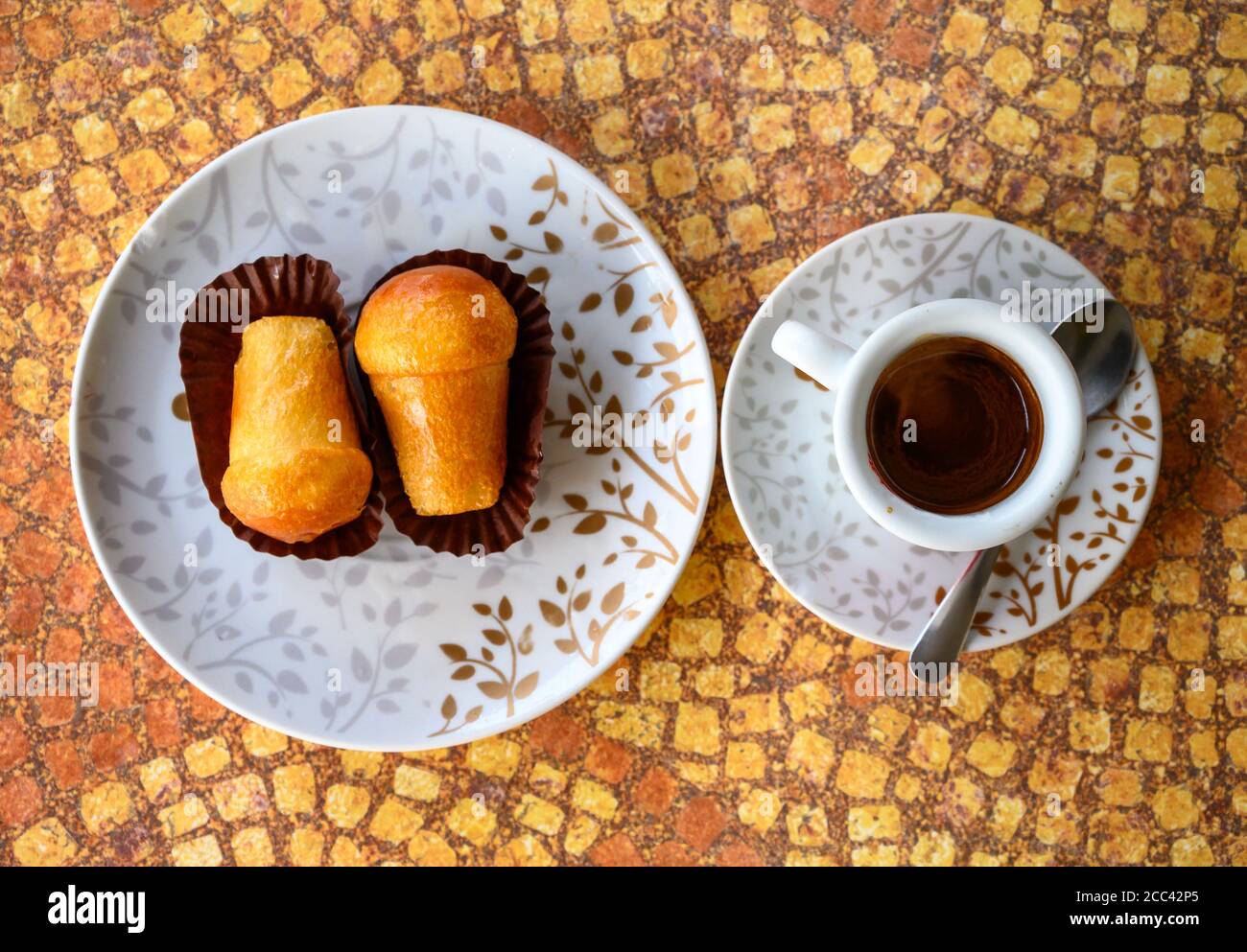 Classic italian espresso coffee served with homemade rum baba soft cake