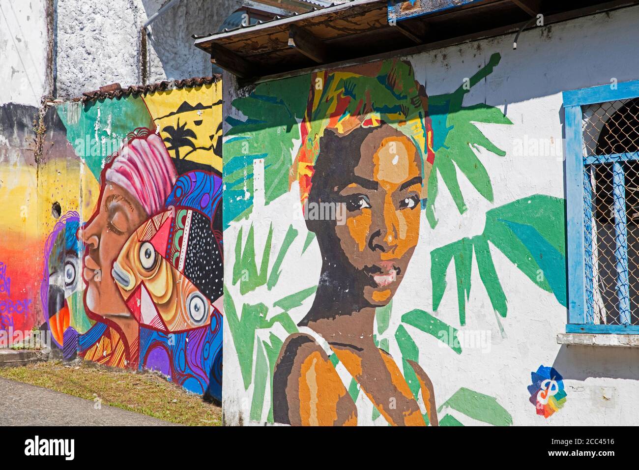 Colourful Garifuna graffiti / wall paintings, street art showing Black Caribs in the town Livingston, Izabal Department, Guatemala, Central America Stock Photo