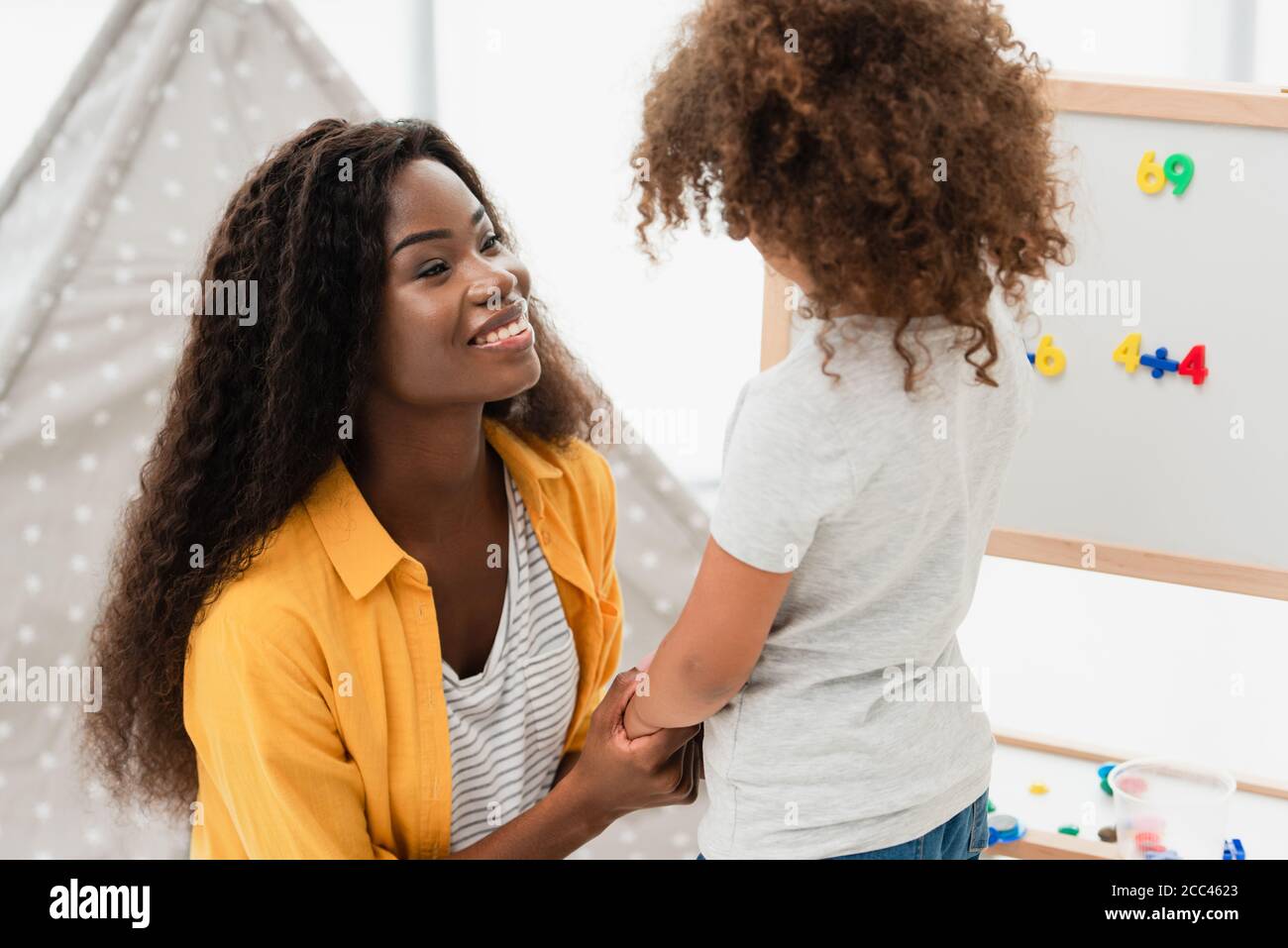 african american mother and daughter holding hands at home Stock Photo ...