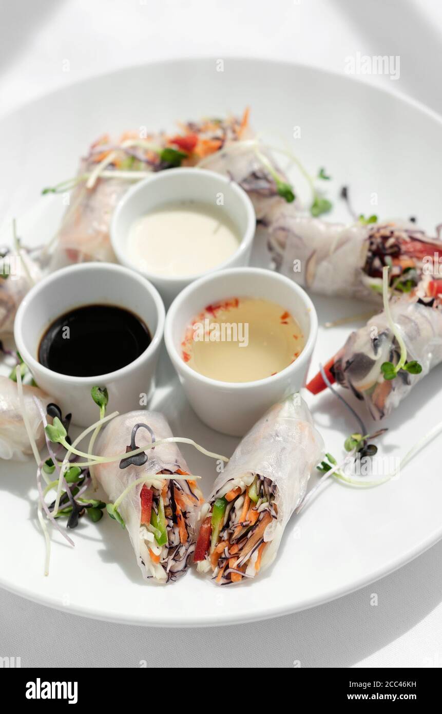 asian fresh vegetable vegan spring rolls with sauces in vietnam Stock Photo