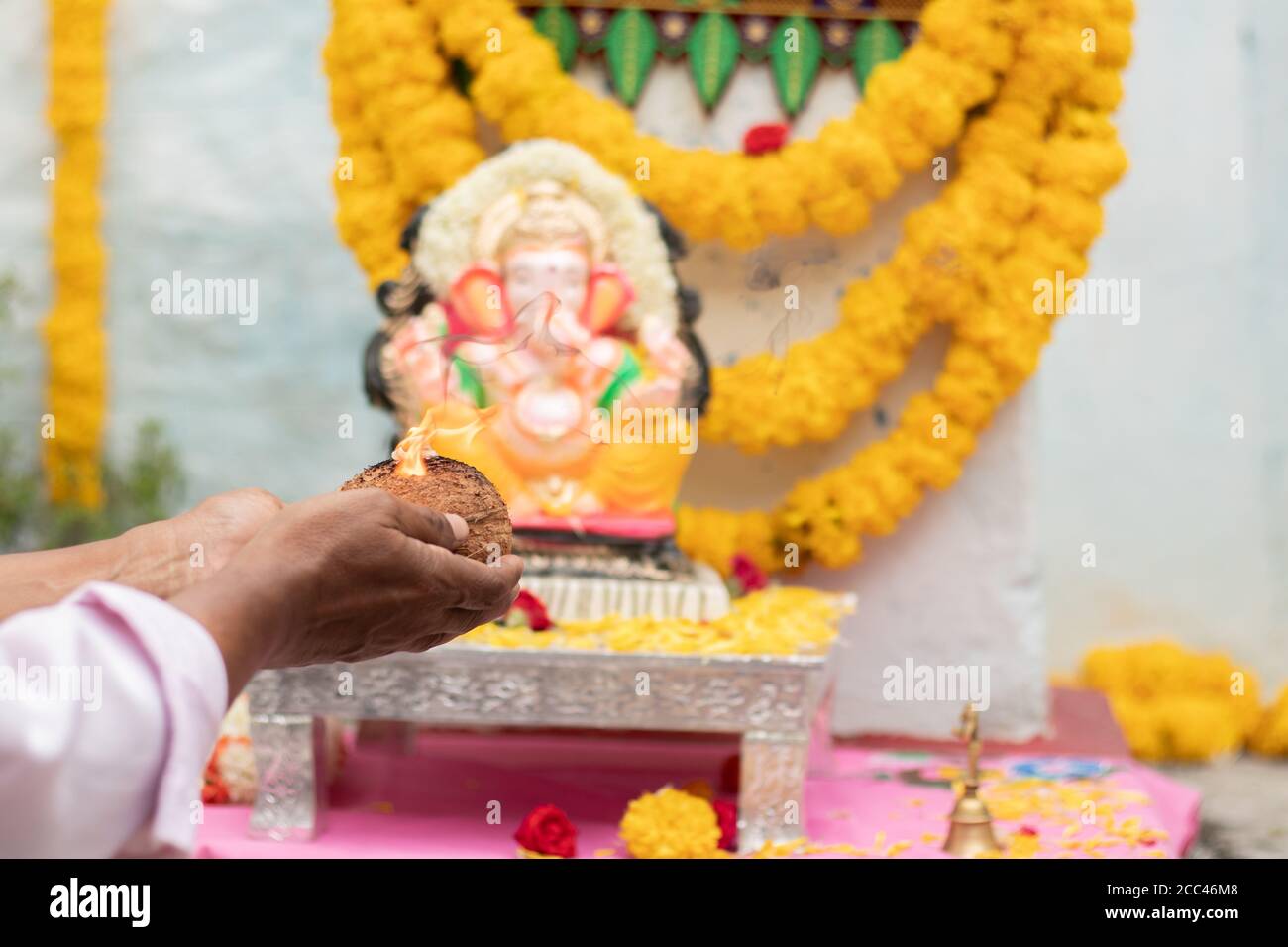 Closeup of Hands worshiping lord ganesh by offering aarti during ...