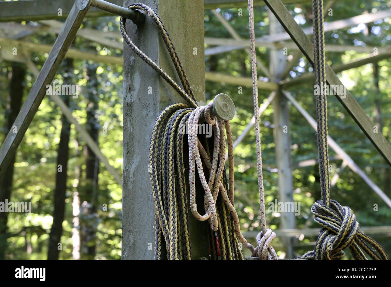 A long rope coil hangs on a metal structure Stock Photo - Alamy