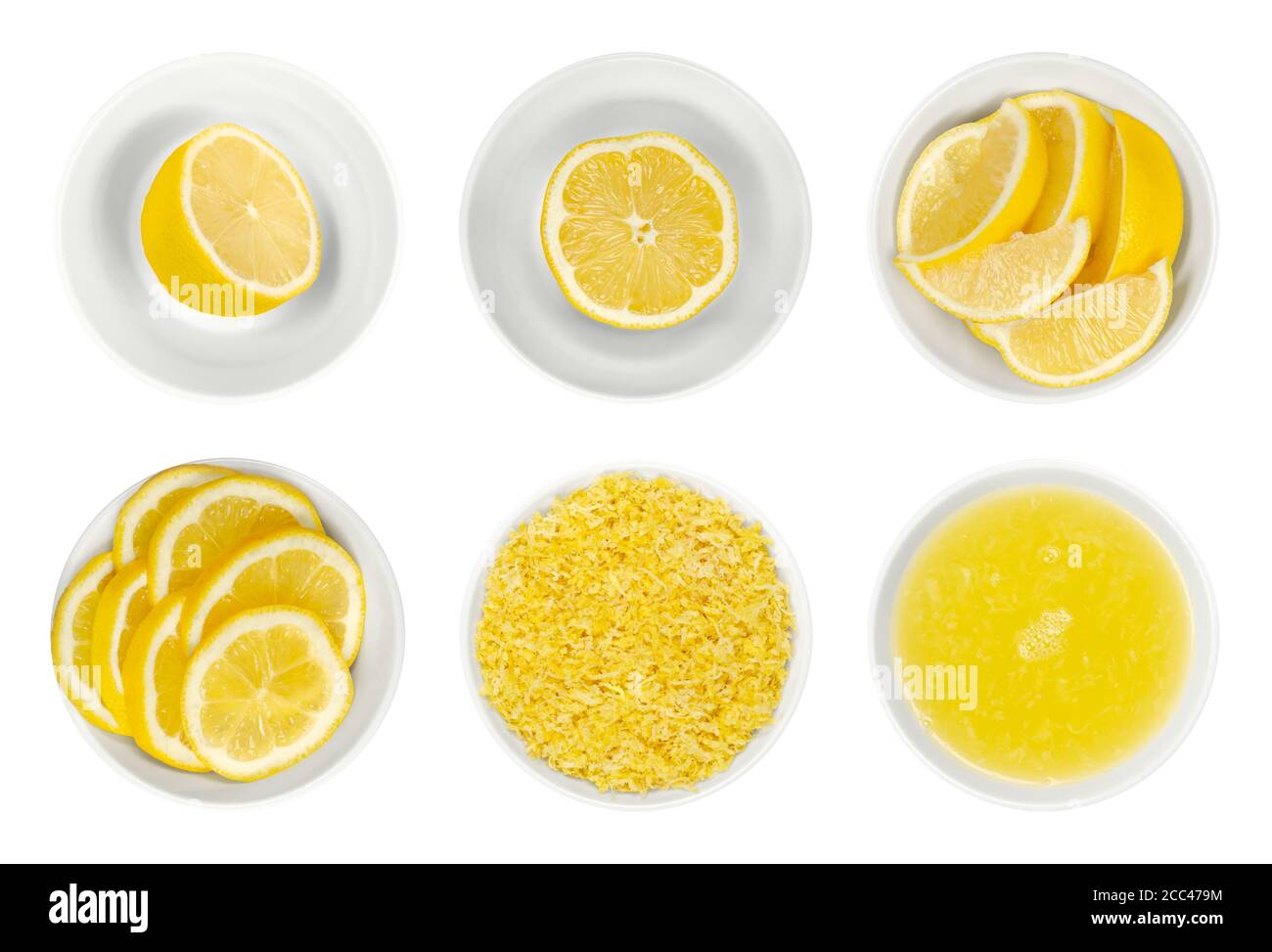 Fresh lemons, cut in half, slices and wedges, lemon zest and juice in white glass bowls. Ripe and yellow citrus fruits, used for culinary and cleaning Stock Photo