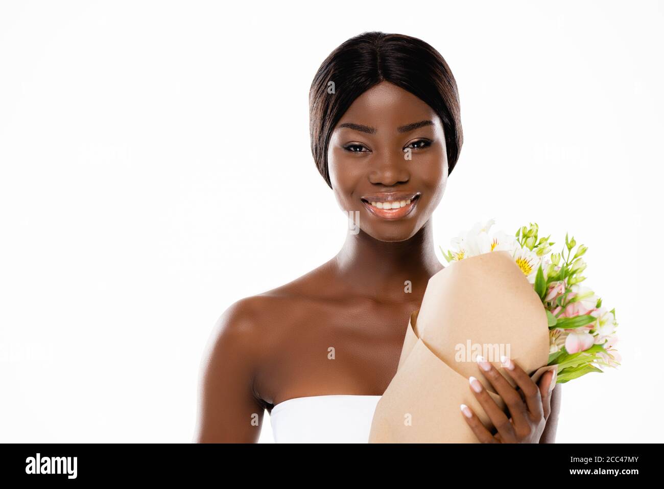 african american woman smiling while holding bouquet of flowers ...