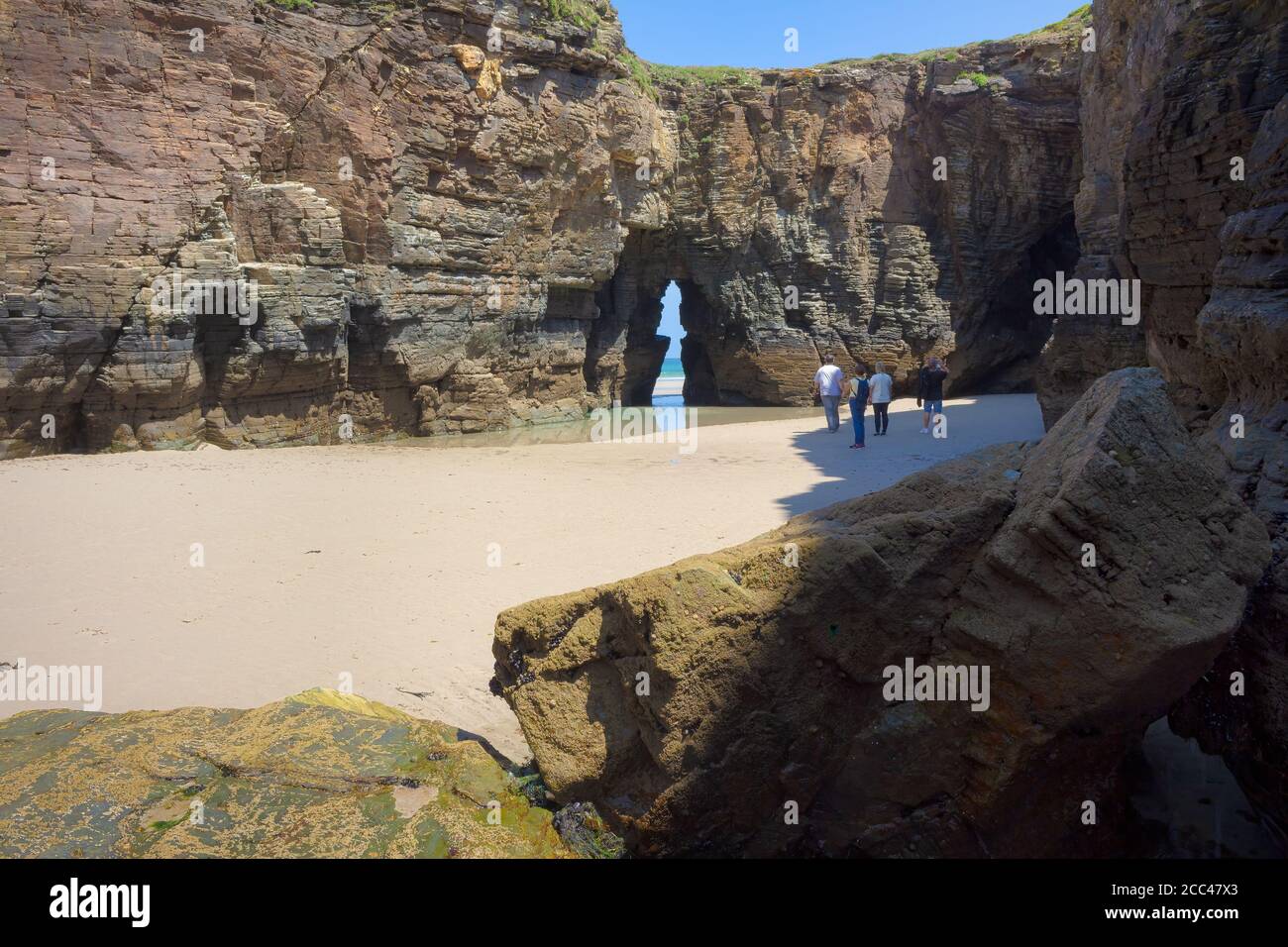 Beach of the Cathedrals, Galicia, Spain- May 2017: When the tide is low you can walk among the impressive cliffs of the Playa de las Catedrales, Galic Stock Photo